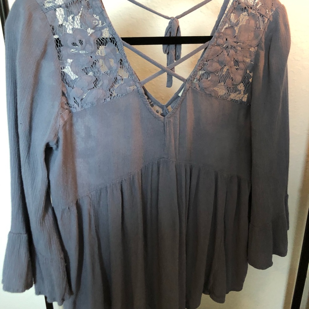 Dusty Blue criss cross v-neck blouse. Lace detail